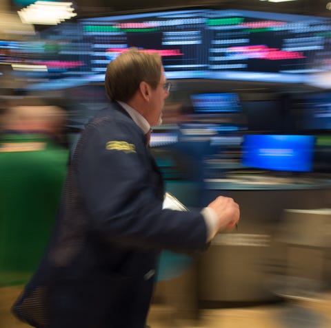 A trader runs across the floor after the Dow Jones