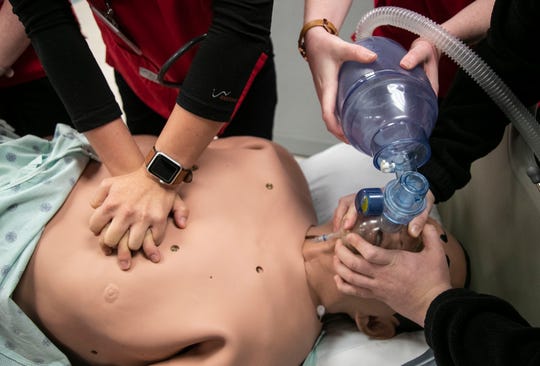 UofL Nursing students work on a training mannequin during a recent class.