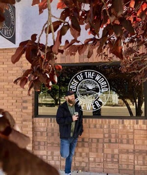 Shad Barlow holds one of the new tulip glasses outside Edge of the World Brewery in Colorado City, Arizona.