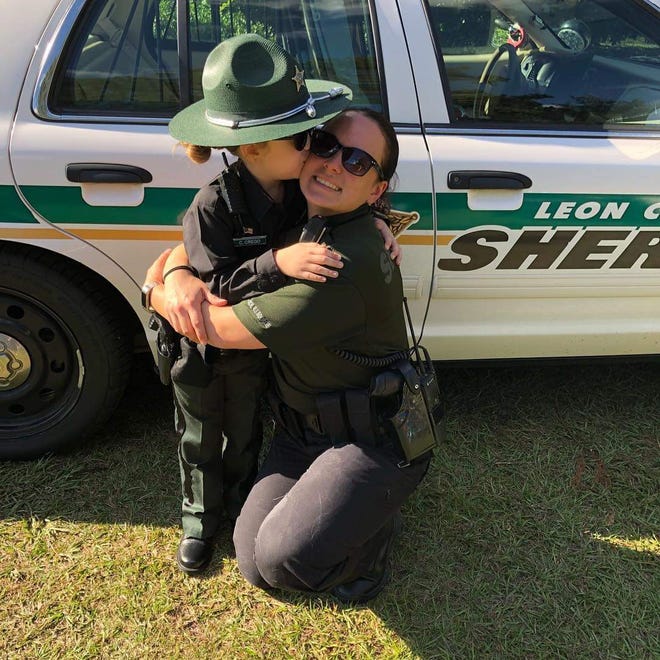 Jessalyn Younger-Gaskins, 5, stands with Leon County Sheriff's Deputy Cecelia Crego. Jessalyn dressed up as the deputy for Halloween.