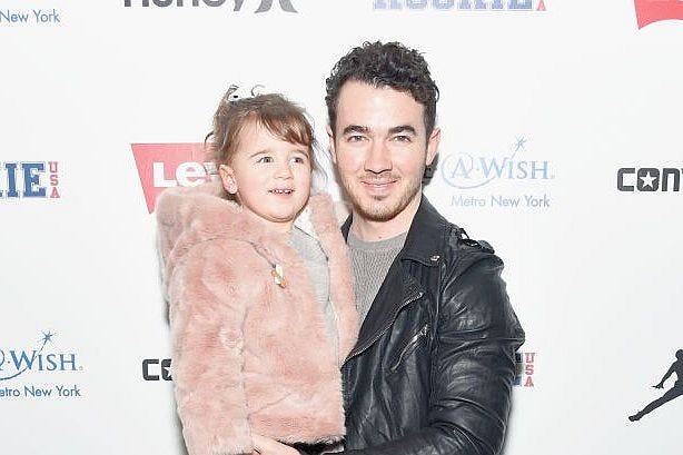 Kevin Jonas holds his oldest daughter, Elena Rose.