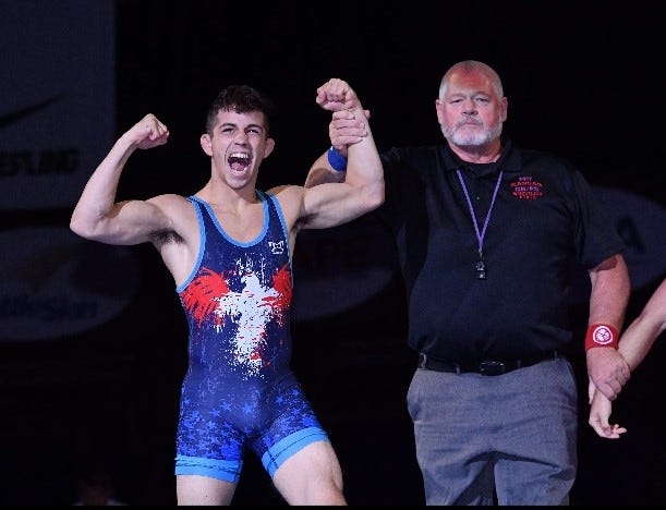 Eric Barnett celebrates a freestyle national title in Fargo, North Dakota, after pinning his opponent in the finals.