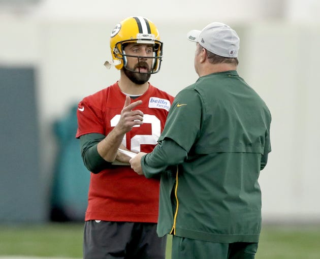 Green Bay Packers quarterback Aaron Rodgers (12) and head coach Mike McCarthy talk during practice Wednesday, November 21, 2018 inside the Don Hutson Center in Ashwaubenon, Wis.