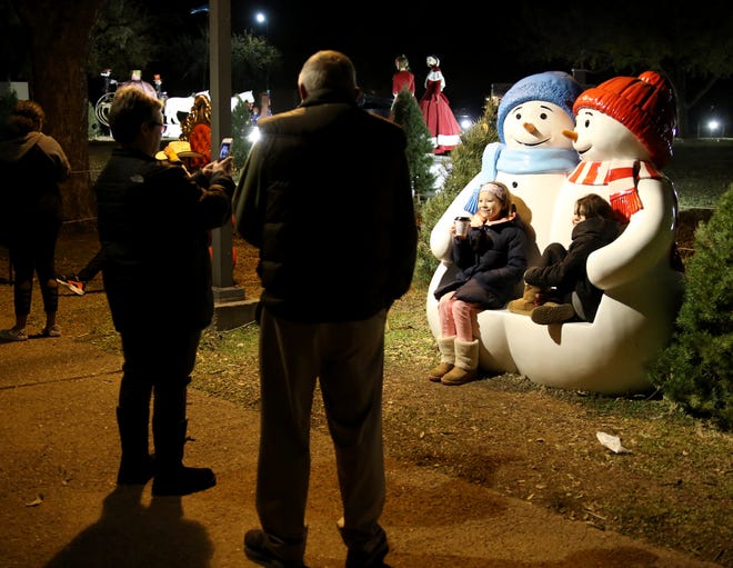 Families walk around the Fantasy of Lights Tuesday, Nov. 20, 2018, in the Midwestern State University front lawn.