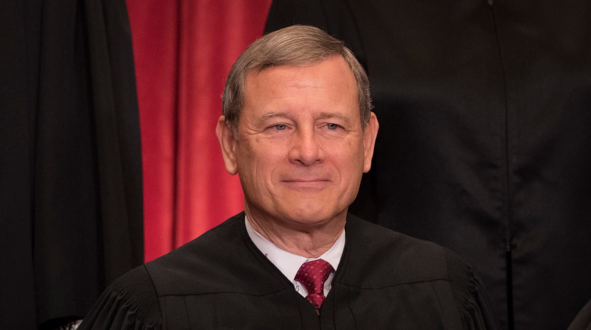 Chief Justice John Roberts poses for a group photo with all nine Supreme Court Justices in the East Conference Room of the Supreme Court Building in Washington on June 1, 2017.