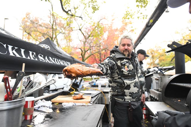 Chef Guy Fieri is among the hundreds of volunteers in downtown Chico, Calif., preparing Thanksgiving dinner on the morning of Nov. 22, 2018 for evacuees of the Camp Fire in Northern California.