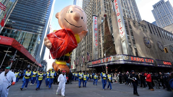 The Charlie Brown balloon makes its way down 6th...