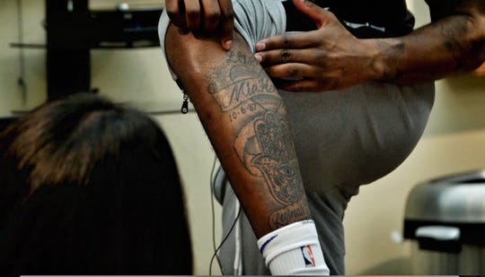 Detroit Pistons forward Reggie Bullock shows off his tattoo memorializing his late transgender sister, Mia Henderson.