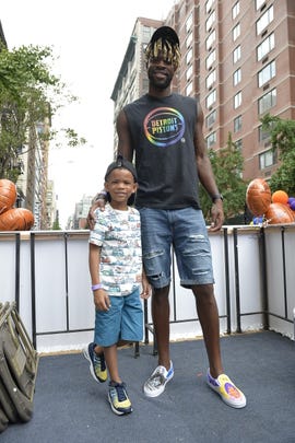 Detroit Pistons forward Reggie Bullock with his son, Treyson, during June's New York City LGBT Pride March.