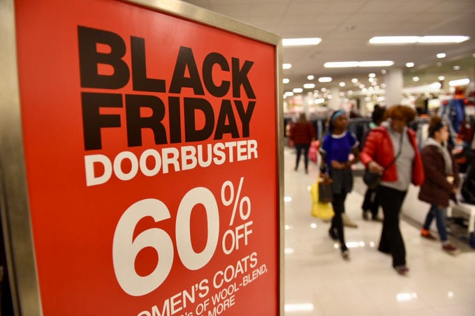 Shoppers crowd Macy’s department store at Twelve Oaks Mall in Novi for their doorbuster sales on Friday, Nov. 23, 2018.