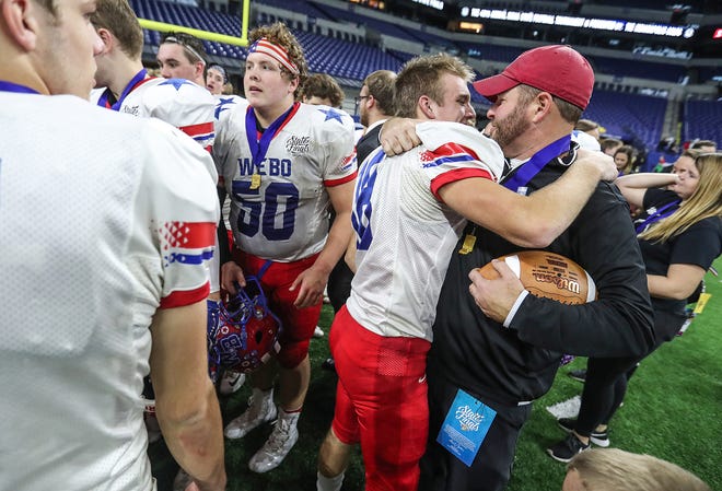 From left, Western Boone Stars Peyton Young (18) and head coach Justin Pelley celebrate after the Stars won their first IHSAA Class 2A state championship since 1988, at Lucas Oil Stadium in Indianapolis, Friday, Nov. 23, 2018.The Stars defeated Eastbrook, 34-20.