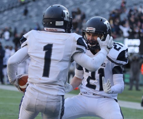 Abellany Mendez of Rutherford celebrates one of his four touchdowns, with team mate Connor Cahill.