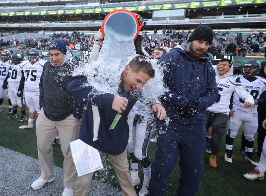 Rutherford head coach Andrew Howell gets the Gatorade shower towards the end of the game as his team won the North Group 2 Championship. 