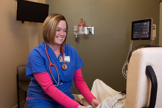 Registered Nurse Kelly Weis attends to a patient at Spearfish Community Hospital.