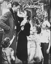 George Bailey (Jimmy Stewart, top left) celebrates Christmas with his wife (Donna Reed) and kids (Larry Simms, Carol Coomes and Jimmy Hawkins) in "It's a Wonderful Life."