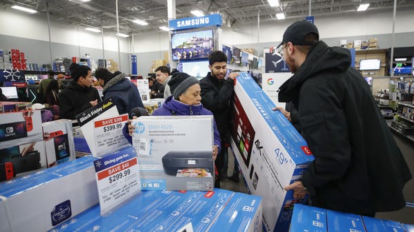 Shoppers pick out flat screen TVs at a Best Buy...