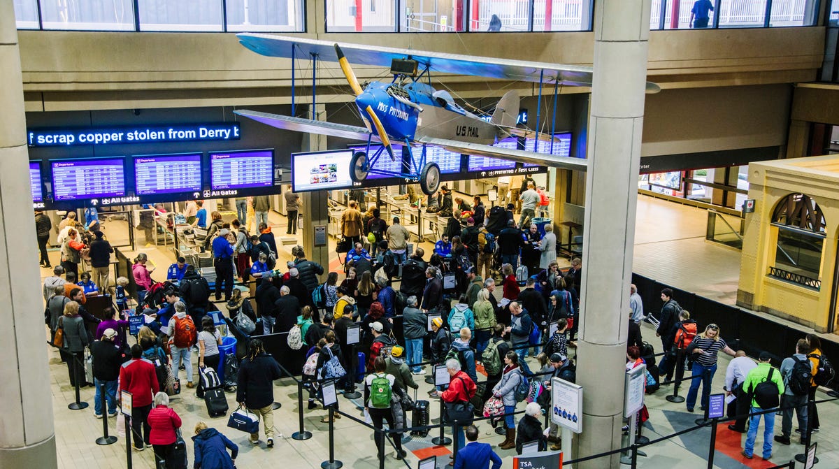 Travelers wait in security lines at the Pittsburgh International Airport on Tuesday, Nov. 20, 2018, in Moon, Pa. Thanksgiving travelers got help from favorable weather in most of the U.S. on Tuesday, but forecasters say a major winter storm across the northern tier could play havoc with travelers heading home during the weekend.'s end.