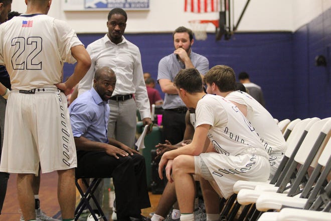 Warren Wilson College head men's basketball coach Anthony Barringer talks to his players during a timeout in a home game against Mars Hill University. The Owls, which play in the USCAA Division II, announced on March 13, they would begin transitioning to NCAA Division III.