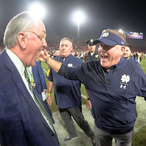 Notre Dame coach Brian Kelly celebrates with...