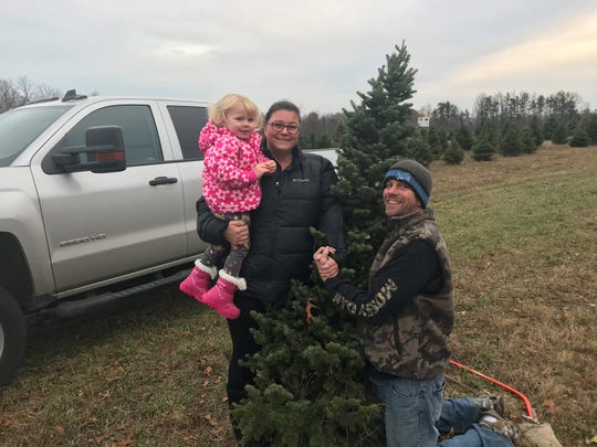 DarShan and Richard Goodman took their daughter, Naomi, 2, to pick out a tree at Wilson's Tannenbaum Farm on Black Friday.