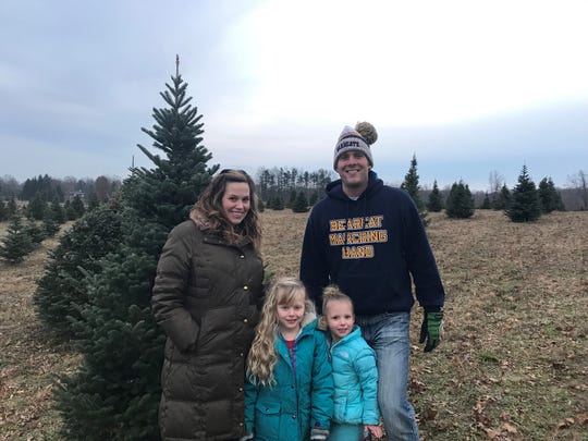 Laura and Noah Hollander took their daughters, Gretta, 6, and Lyza, 4, to Wilson's Tannenbaum Farm to get a tree for this holiday season.