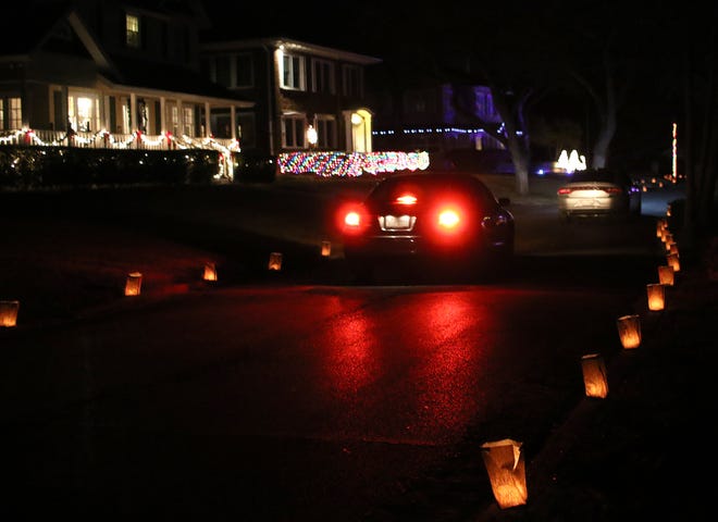 Morningside Luminaries on display for Christmas. Cars drive through Morningside Addition to see more than 1,500 candles inside paper bags and homes decorated with Christmas lights.