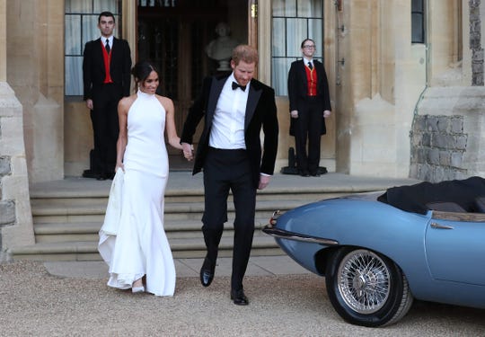 Prince Harry, Duchess Meghan of Sussex, leaves Windsor Castle on May 19, 2018 after their wedding to attend an evening reception at Frogmore House.
