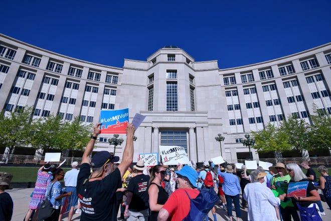 Over 100 demonstrators rally outside the Michigan Hall of Justice Wednesday, July 18, 2018, where the Michigan Supreme Court heard arguments on whether the constitution should be amended by voters to change the way political districts are made.