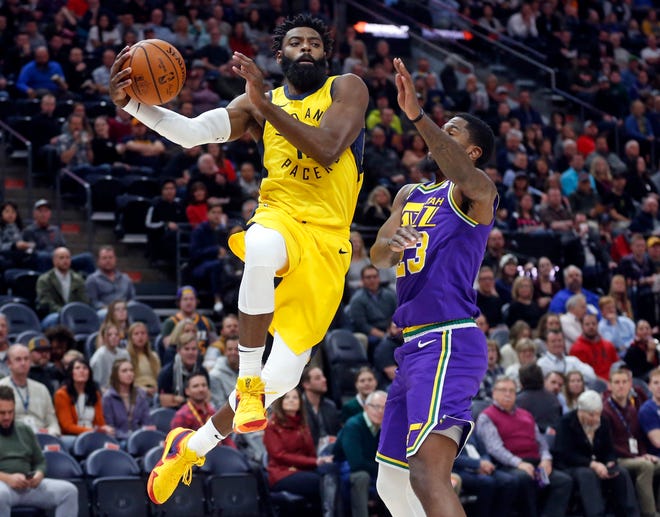 Indiana Pacers guard Tyreke Evans, left, drives to the basket as Utah Jazz forward Royce O'Neale, right, defends in the first half during an NBA basketball game Monday Nov. 26, 2018, in Salt Lake City.