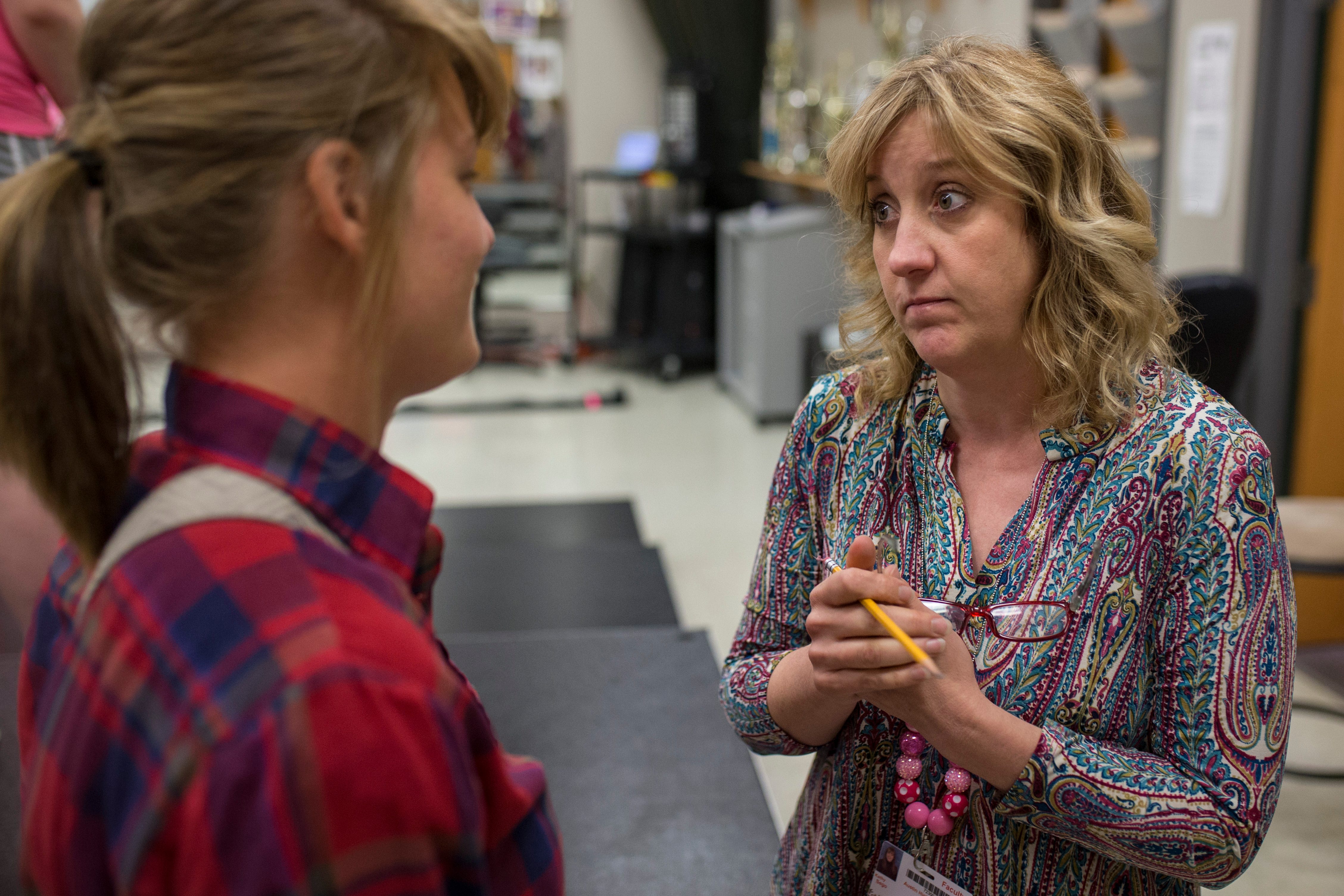 Former Austin High School show choir team member Kasey Brandenburg, left, has a parent-like conversation about boys with show choir instructor Kathy Risk-Sego before Brandenburg left for college at Ball State. “I worry during breaks and when they go to college,” Risk-Sego said. “I text. I call. I follow them on everything. Sometimes they just need someone to check-in and hold them accountable.” Aug. 13, 2018