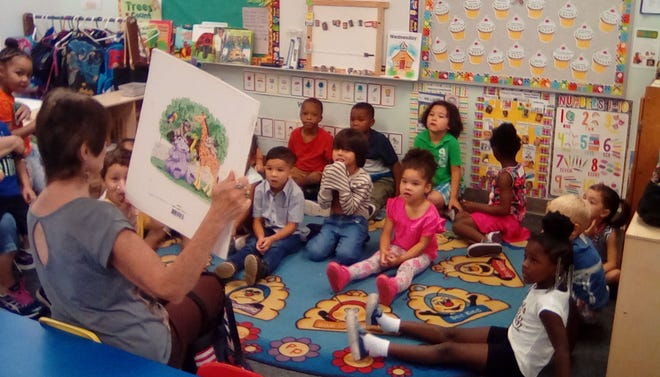 Community volunteer reads to children during Head Start Community Read Week. School districts across the Treasure Coast are encouraging families to participate in the census, which provides federal funds to programs such as Head Start.