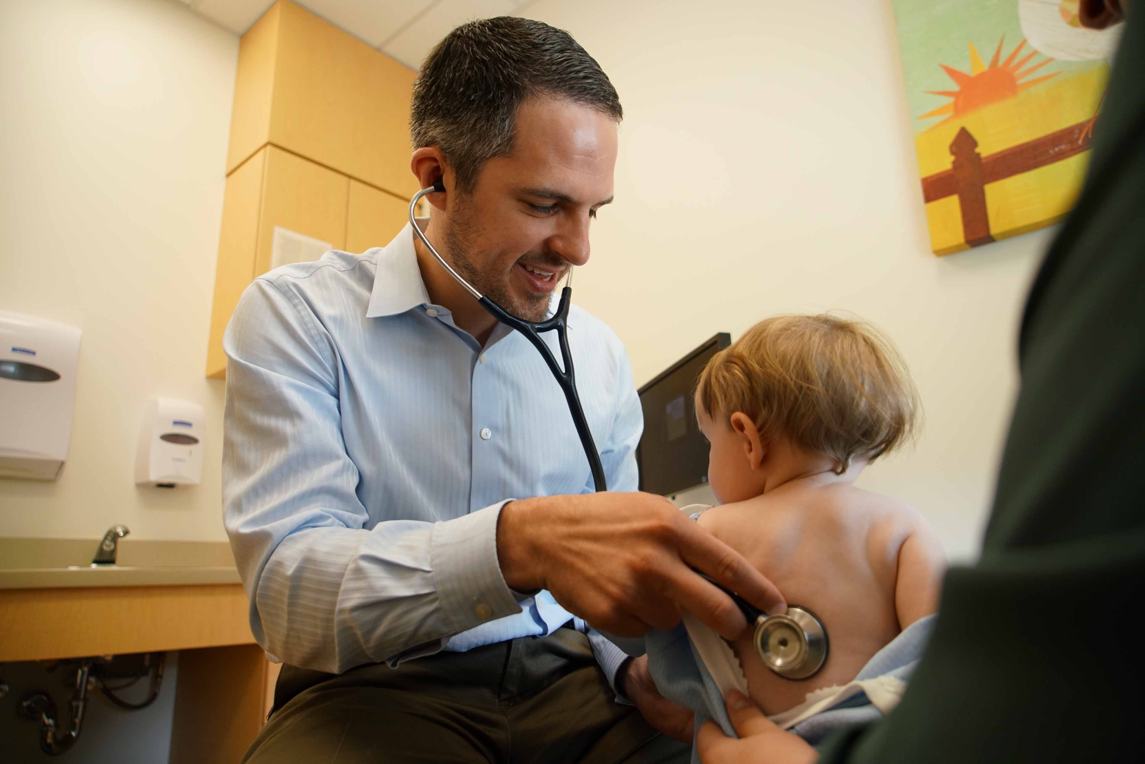 Dr. Matt Demczko, a doctor who helps run the Nemours Kinder Clinic in Dover, examines a young Amish boy.