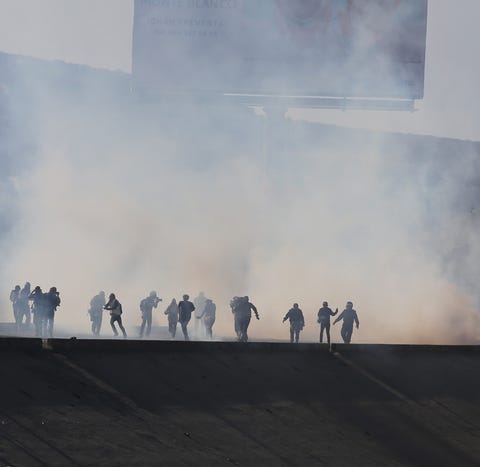 Border police fire tear gas at migrants in...