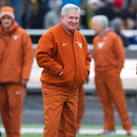 Mack Brown stands on the field before Texas...
