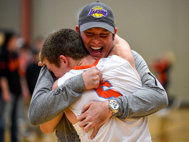 South Gibson's Nathan Hicks (5) embraces his father David Hicks after winning a TSSAA boys basketball game between South Gibson and Haywood High Schools at South Gibson High School in Medina, Tenn., on Tuesday, Nov. 27, 2018.