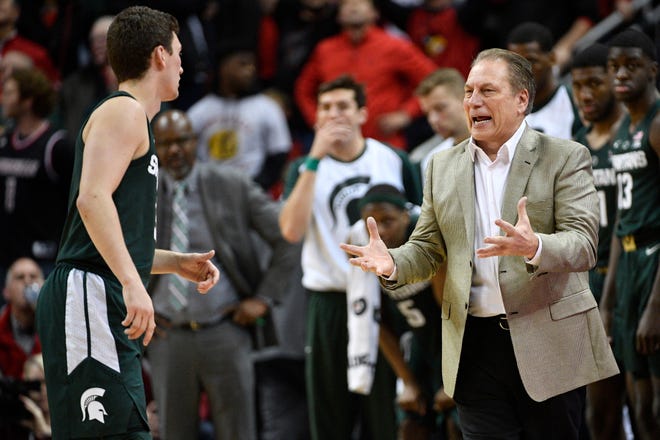 Michigan State coach Tom Izzo talks with guard Foster Loyer during overtime Tuesday night at Louisville.