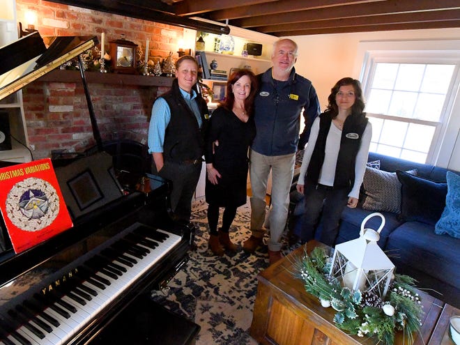 Owners and innkeepers Brian Westenberg and Katherine Rook stand with assistant innkeeper Gretchen Daub (left) and marketing specialist Amber Hancock (right) in the living room at the Inn at WestShire Farms in Staunton on Wednesday, Nov. 28, 2018.