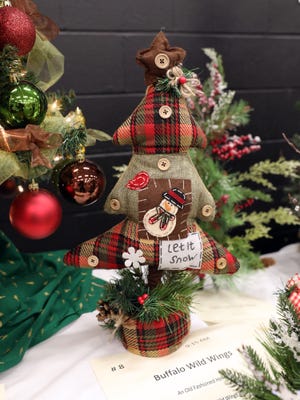 This 20" cloth plaid Christmas tree will bring warmth to the holidays with red, green and brown plaid, and buttons.