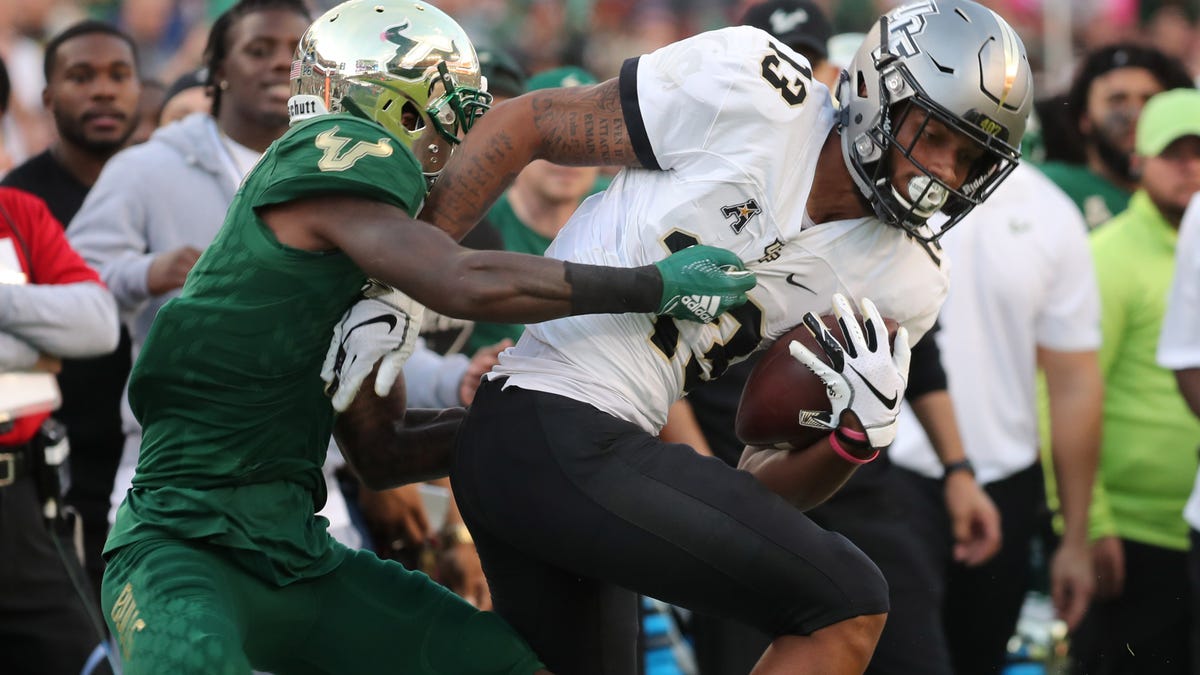 Central Florida wide receiver Gabriel Davis is tackled South Florida defensive back Mike Hampton during the first quarter at Raymond James Stadium.