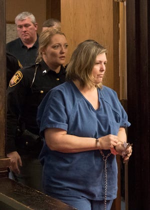 Angela Wagner, 48, of South Webster, is escorted by deputies into Judge Randy DeeringÕs court for her arraignment at the Pike County Courthouse on Thursday, Nov. 29, 2018.