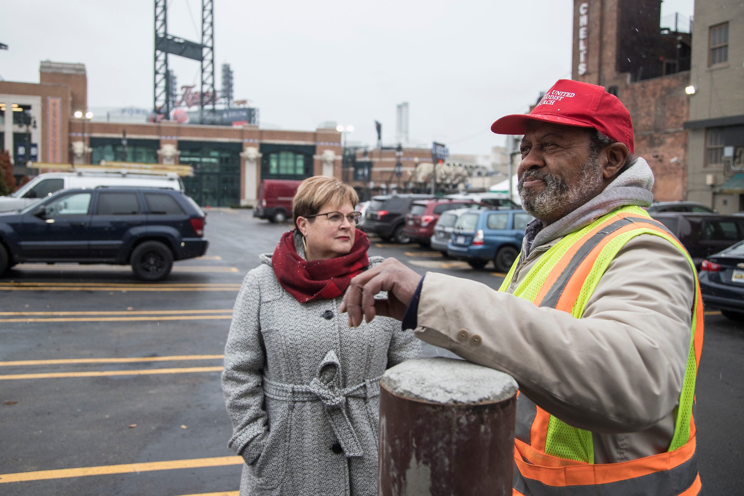 Central United Methodist Church senior pastor Jill Hardt Zundel talks with Reginald Alan, right, who manages the church's parking lot in Detroit, Thursday, Nov. 29, 2018.