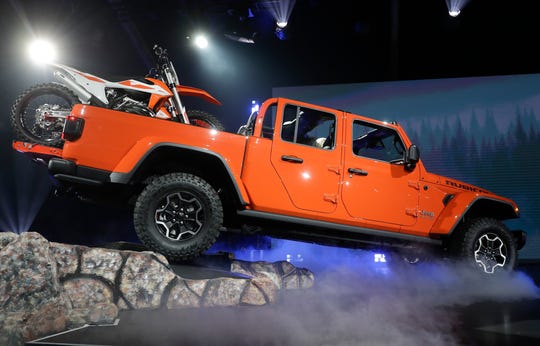 A 2020 Jeep Gladiator Rubicon climbs into the stage during the Los Angeles Auto Show on Wednesday.