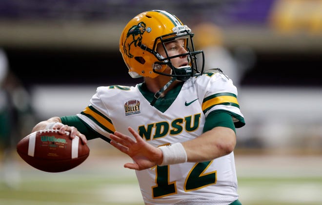 FILE - In this Saturday, Oct. 6, 2018, file photo, North Dakota State quarterback Easton Stick warms up before an NCAA college football game against Northern Iowa, in Cedar Falls, Iowa. North Dakota State begins its hunt for its seventh Football Championship Subdivision title in eight years with a familiar ingredient on offense: a high-quality quarterback with plenty of experience in senior Stick. (AP Photo/Charlie Neibergall, File)