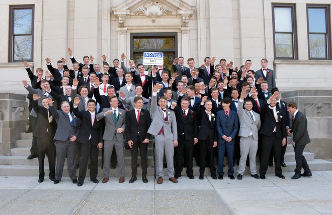 In this May 2018 photo provided by Peter Gust, a group of Wisconsin high school boys stand on the steps outside the Sauk County Courthouse in Baraboo. The image has drawn widespread condemnation because of the appearance that some of the students are giving a Nazi salute.