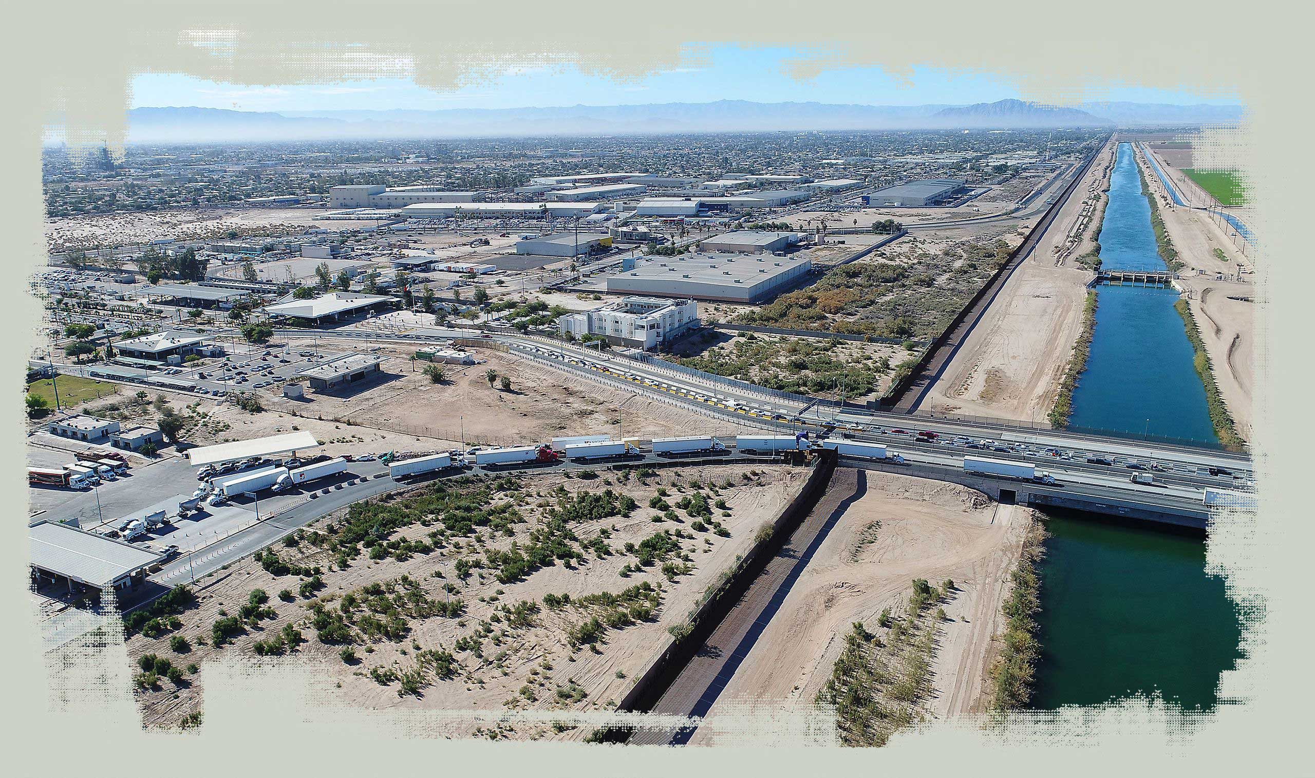 Cars and trucks line up to cross from Mexicali into California. Running along the border is the All-American Canal, which delivers Colorado River water to farmland in the Imperial Valley.