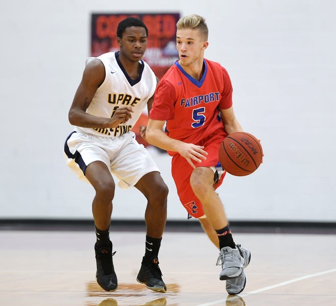 Fairport's Ryan Kennedy, right, dribbles past University Prep's Harold Boggs McCulough during a regular season game played at Roberts Wesleyan College on Wednesday, Nov. 28, 2018. Fairport beat University Prep 56-51.