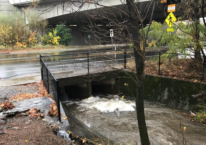 File photo - Water rushes into a storm drain in 2018 off Park Marina Drive in Redding.