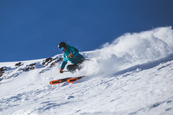 An instructor shows how to ski the high alpine terrain near the peak of Whistler.