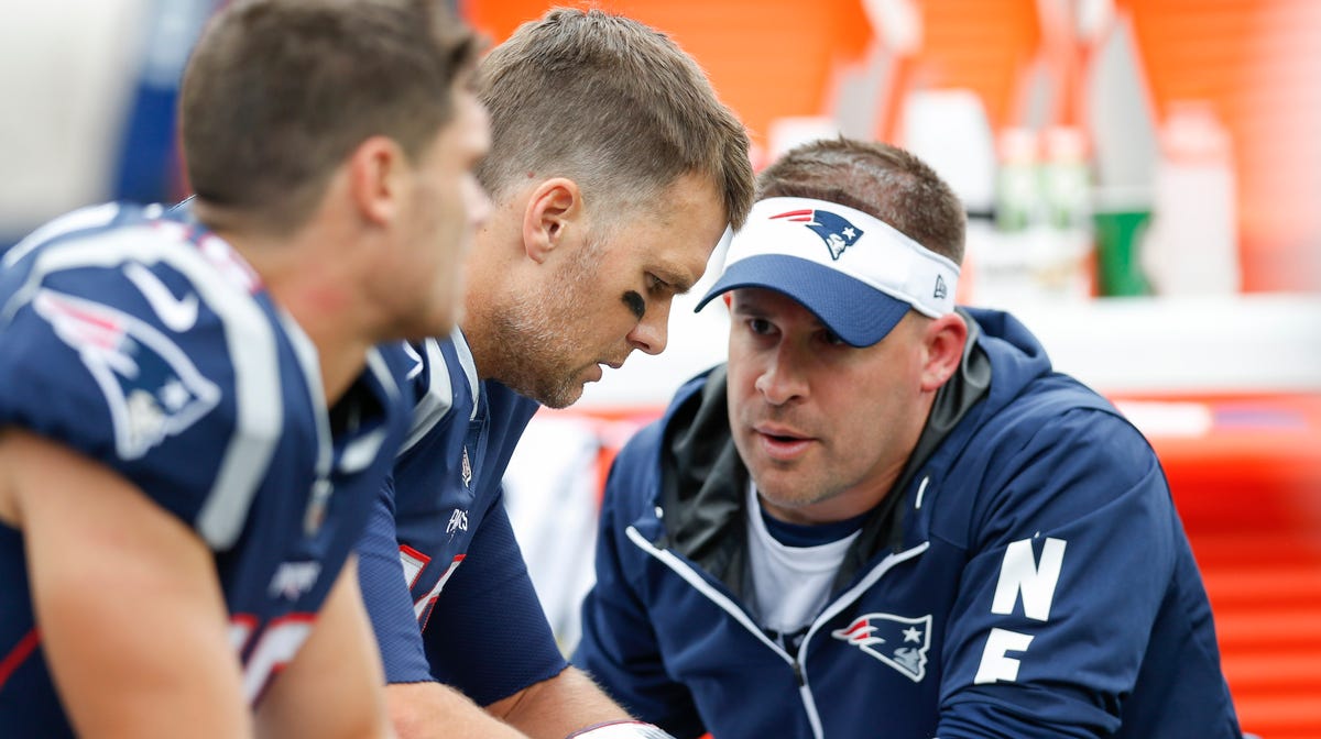 New England Patriots quarterback Tom Brady (12) talks with offensive coordinator Josh McDaniels during the second quarter against the Houston Texans at Gillette Stadium.