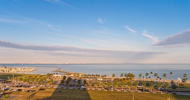 High atop a lush hillside overlooking Corpus Christi Bay, The Cliff House hi rise casts it's shadow over the Corpus Christi bay front and a beautiful afternoon.  This is the view from one of the balconies in this amazing condo.